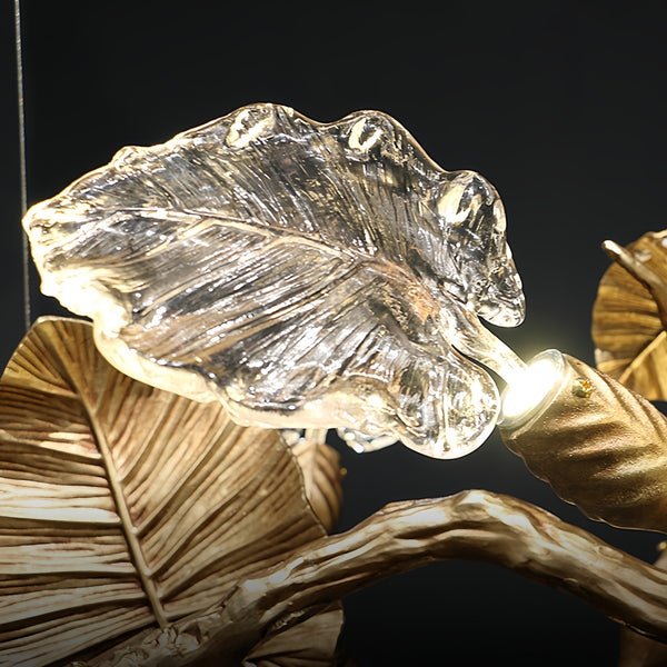 Elegant Lotus chandelier featuring delicate lotus leaf pendants made of transparent material, capturing light with a crystalline shimmer. The slender, organic brass copper branch adds warmth, while the LED lights provide a cool glow. Ideal centerpiece for a sophisticated dining area or tranquil bedroom retreat.