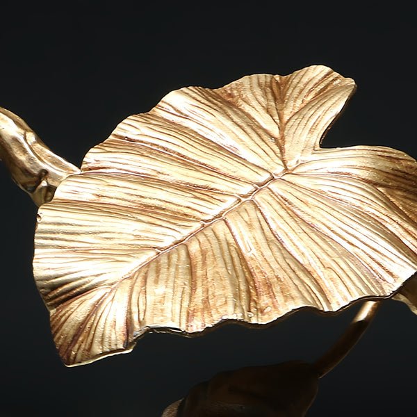 Elegant Lotus chandelier featuring delicate lotus leaf pendants made of transparent material, capturing light with a crystalline shimmer. The slender, organic brass copper branch adds warmth, while the LED lights provide a cool glow. Ideal centerpiece for a sophisticated dining area or tranquil bedroom retreat.