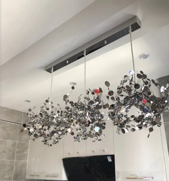 High-quality stainless steel Aurora chandelier with G9 light sources, available in Golden and Chrome finishes. Perfect for living rooms, dining rooms, bedrooms, villas, and lobbies, this versatile design blends luxury and functionality for a brilliant and inviting ambiance.