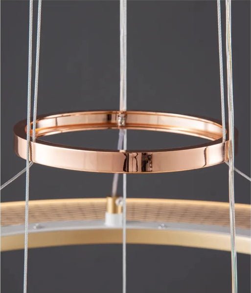 Dröme modern LED chandelier with sculptural acrylic rings and soft ambient glow, Nordic-style ceiling light ideal for living rooms, bedrooms, stairwells, and hotel lobbies.